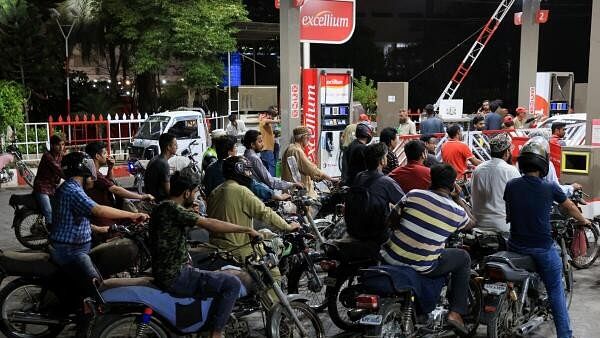 <div class="paragraphs"><p>People wait for their turn to get fuel at a petrol station, after petrol dealers across the country annouced they are going on strike against taxes imposed by the government, in Karachi, Pakistan July 4, 2024. </p></div>