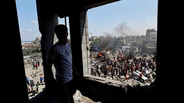 <div class="paragraphs"><p>Palestinians gather near damage, following what Palestinians say was an Israeli strike at a tent camp in Al-Mawasi area, amid Israel-Hamas conflict, in Khan Younis in the southern Gaza Strip July 13, 2024.</p></div>