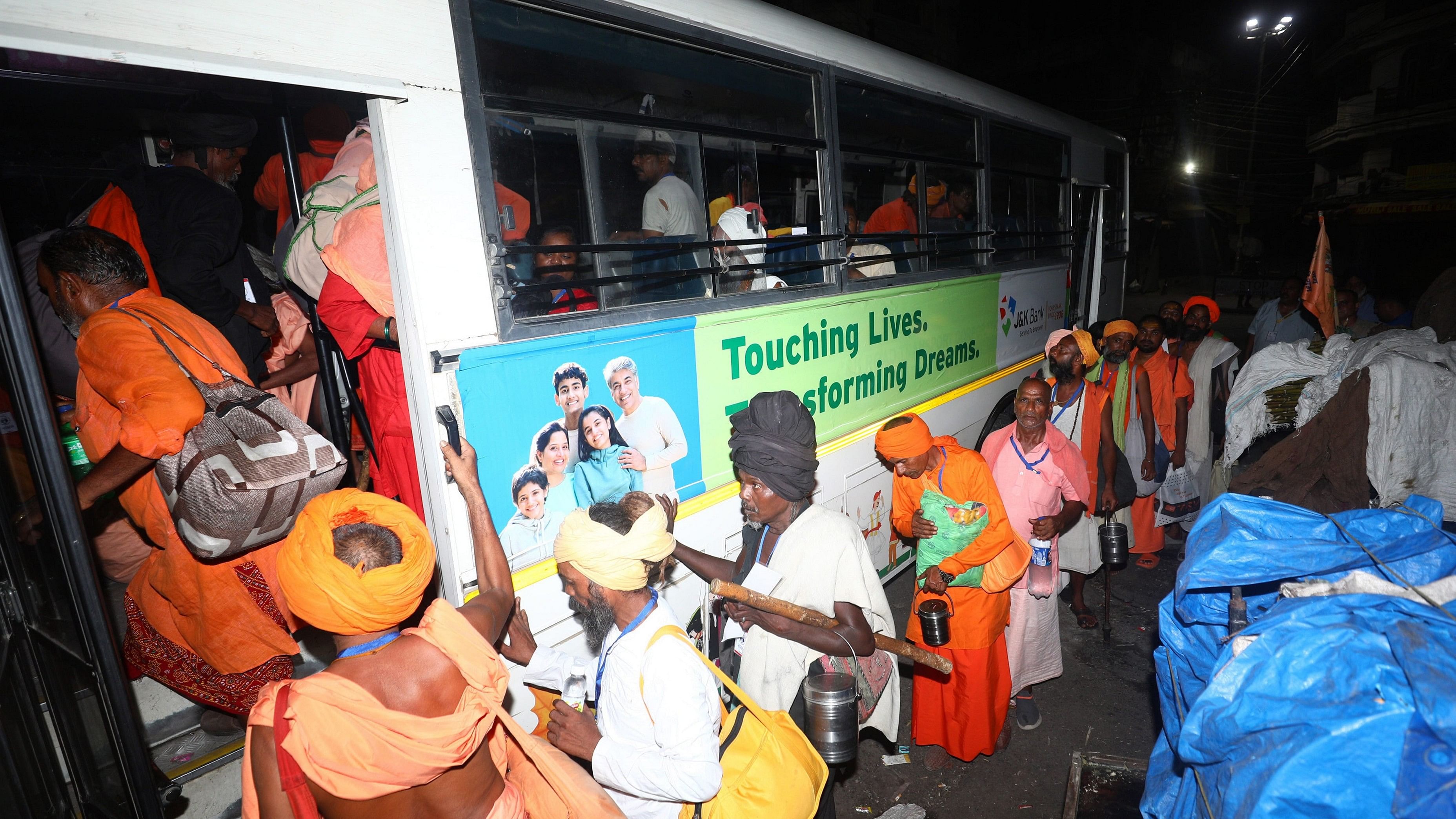 <div class="paragraphs"><p> Sadhus board a bus before leaving for the annual Amarnath Yatra, in Jammu.</p></div>