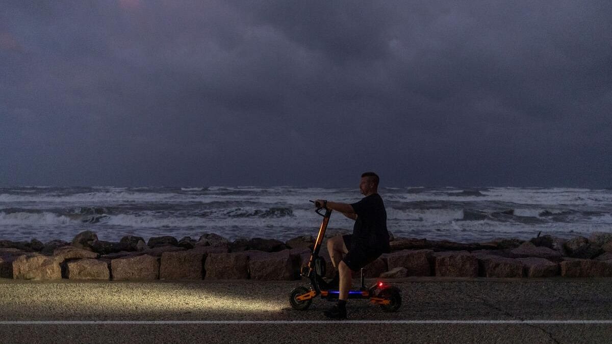 <div class="paragraphs"><p>Resident watches swells from Hurricane Beryl from electric scooter in Surfside Beach, Texas</p></div>