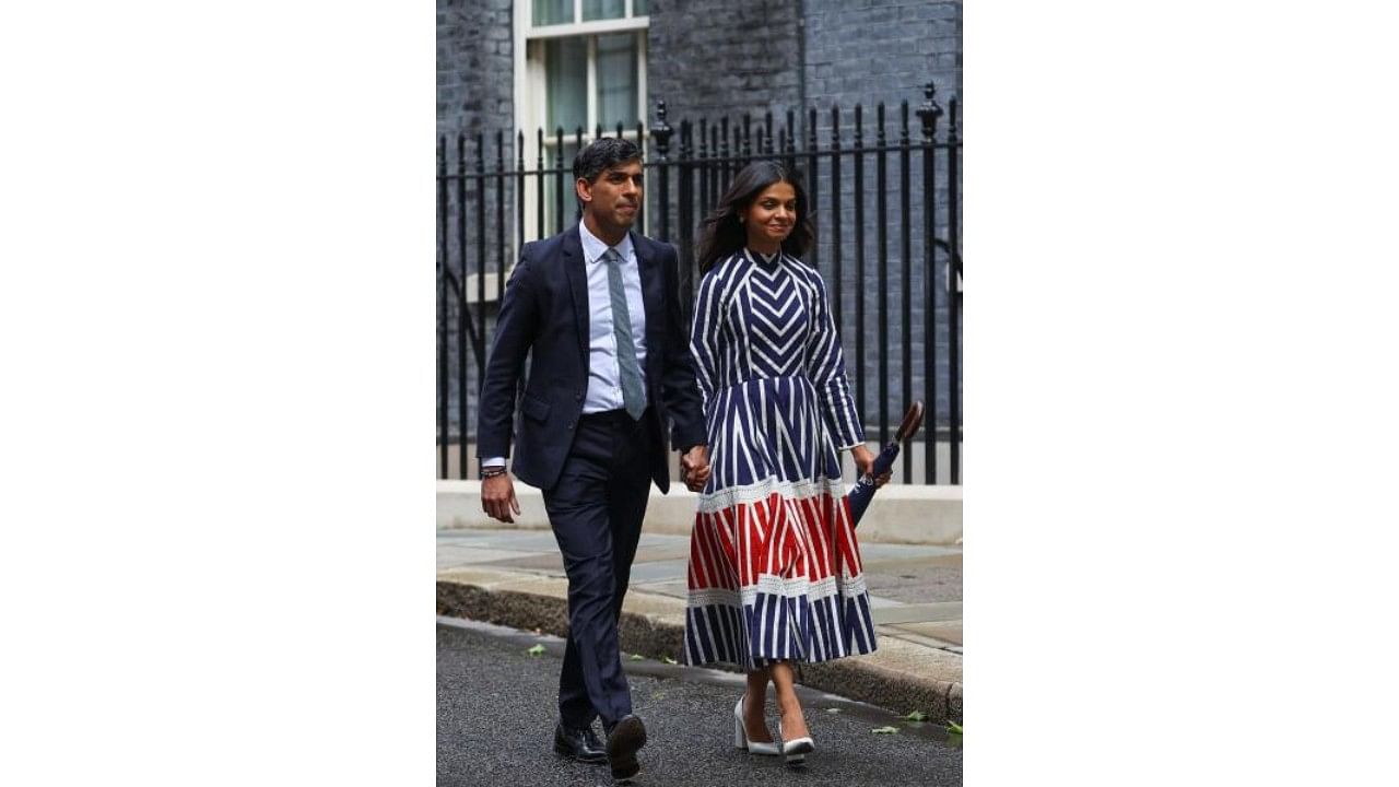 <div class="paragraphs"><p>Outgoing British Prime Minister Rishi Sunak walks with his wife Akshata Murty after delivering a speech at Number 10 Downing Street, following the results of the elections, in London, Britain.</p></div>