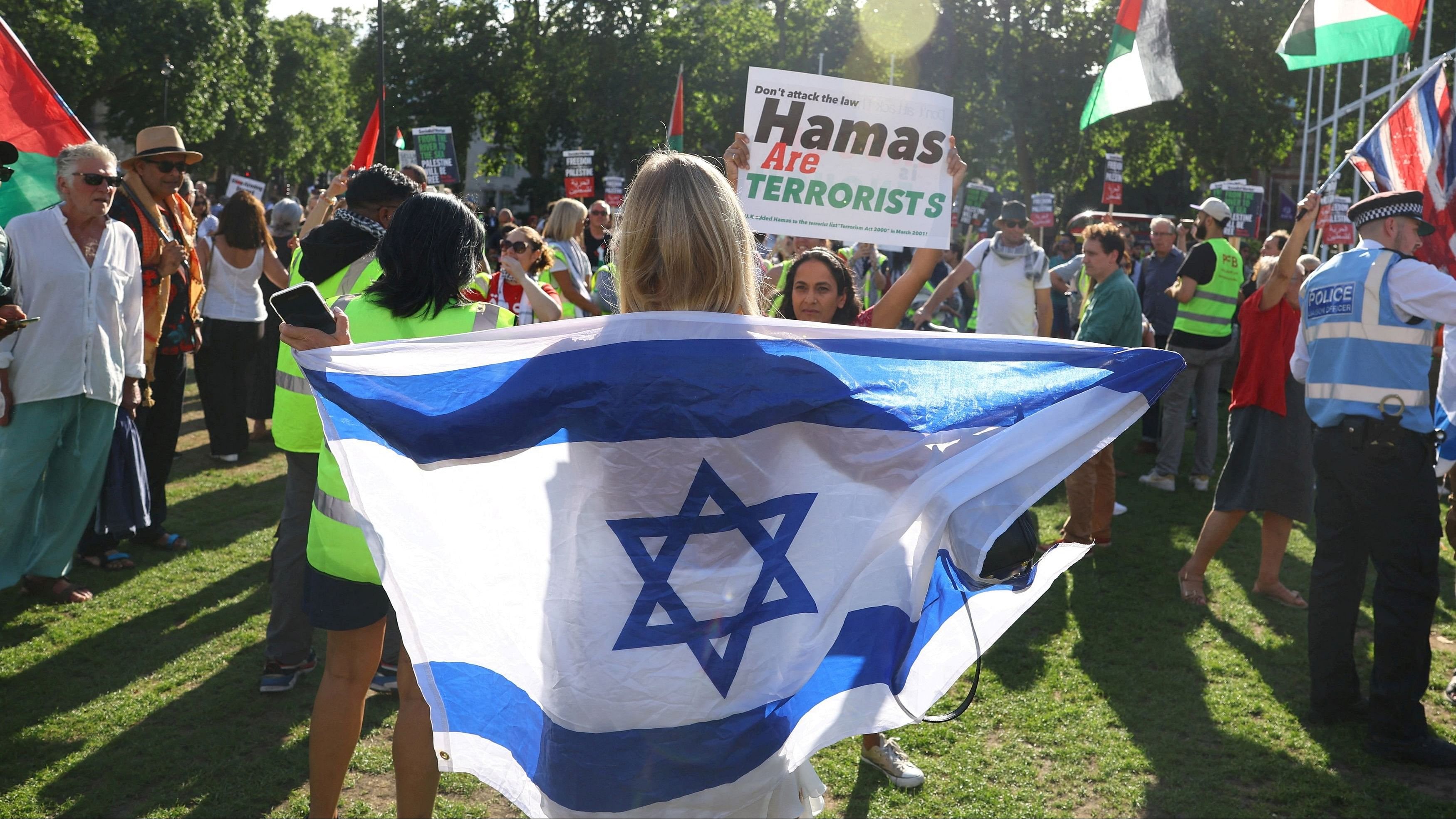 <div class="paragraphs"><p>A person in support of Israel holds a flag as demonstrators gather to protest in solidarity with Palestinians, amid the ongoing conflict between Israel and the Palestinian Islamist group Hamas, outside of the Houses of Parliament, London.</p></div>