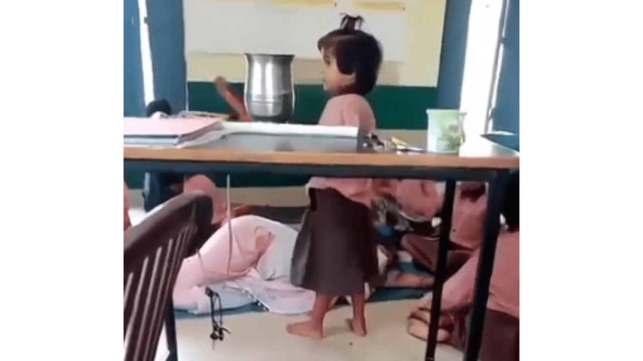 <div class="paragraphs"><p>Screengrab of video showing small children fanning the teacher who was seen sleeping in the classroom.</p></div>