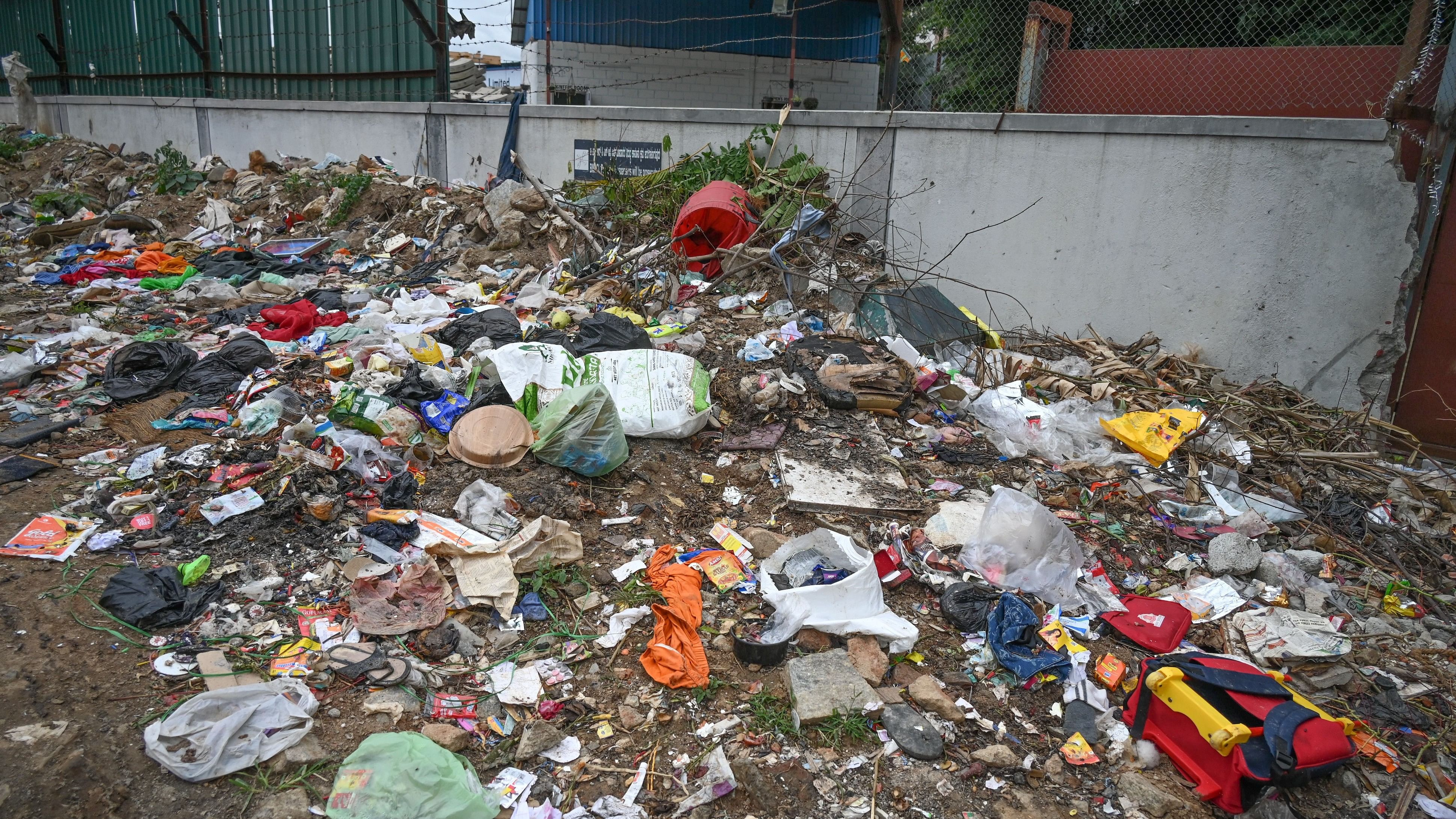 Garbage is being dumped and strewn around outside the premises of Jal Vayu Towers in NGEF Layout.