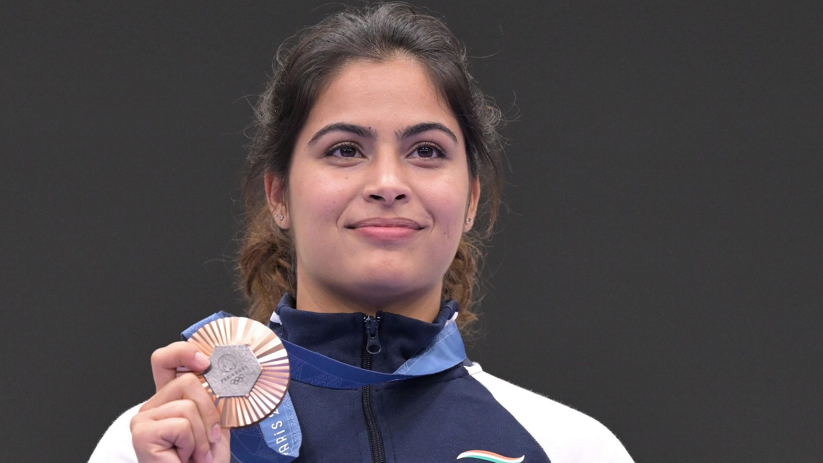 <div class="paragraphs"><p> Manu Bhaker poses for a photograph with her bronze medal after finish third in the 10m air pistol women's final round at the 2024 Summer Olympics, France, Sunday, July 28, 2024. </p></div>