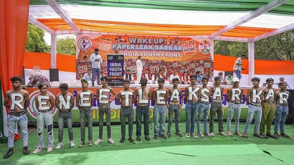 <div class="paragraphs"><p>Members of India Youth Front, an umbrella group representing INDIA bloc parties' youth wings, stage a protest over the alleged irregularities in NEET 2024 results, at Jantar Mantar, in New Delhi, Monday, July 8, 2024.</p></div>