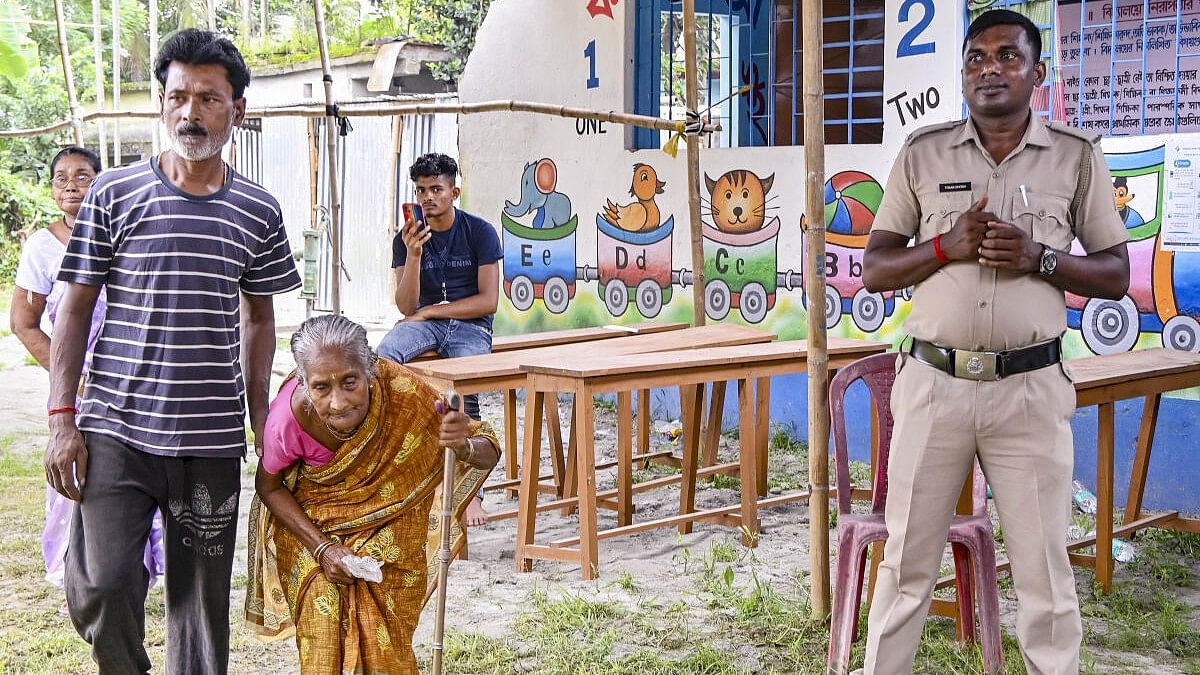 <div class="paragraphs"><p>A man assists an elderly woman as she arrives to cast her vote at a polling station during the ongoing Raiganj assembly bypoll, in North Dinajpur, Bengal.&nbsp;</p></div>