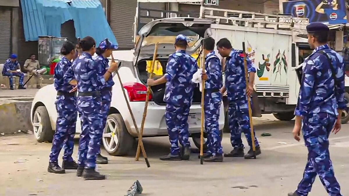 <div class="paragraphs"><p>Security personnel check a vehicle ahead of the Braj Mandal Jalabhishek Yatra which saw violence last year, in Nuh, Monday, July 22, 2024. </p></div>