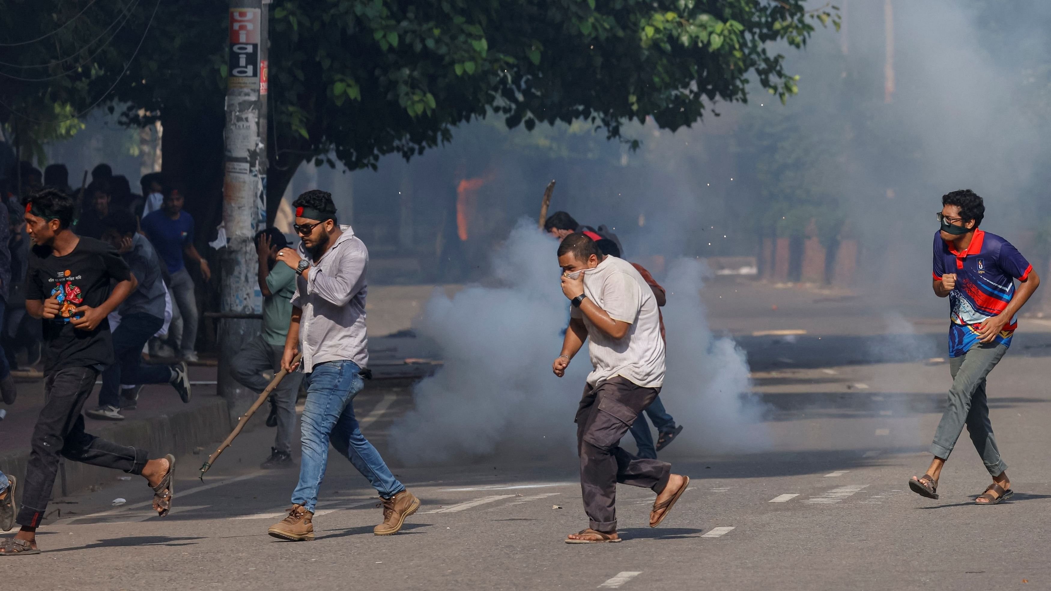 <div class="paragraphs"><p>People run as police fire teargas during a coffin rally of anti-quota protesters at the University of Dhaka.</p></div>