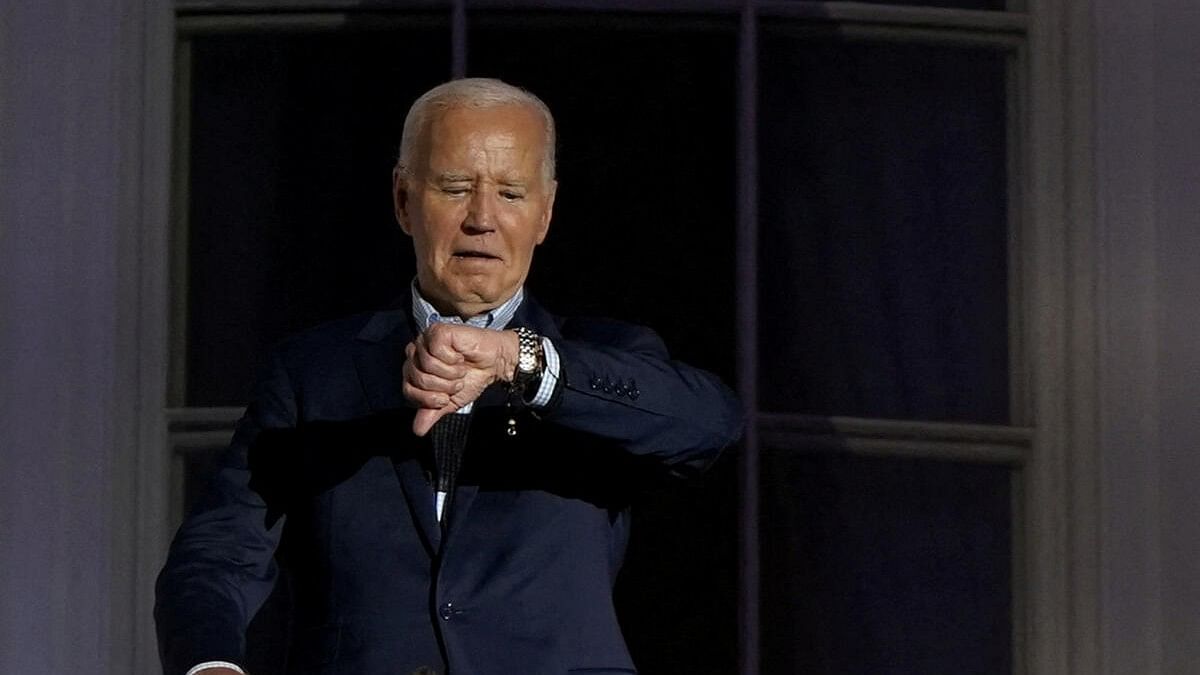 <div class="paragraphs"><p>US President Joe Biden looks at his watch as he stands on the balcony during an Independence Day celebration on the South Lawn of the White House in Washington, US.</p></div>