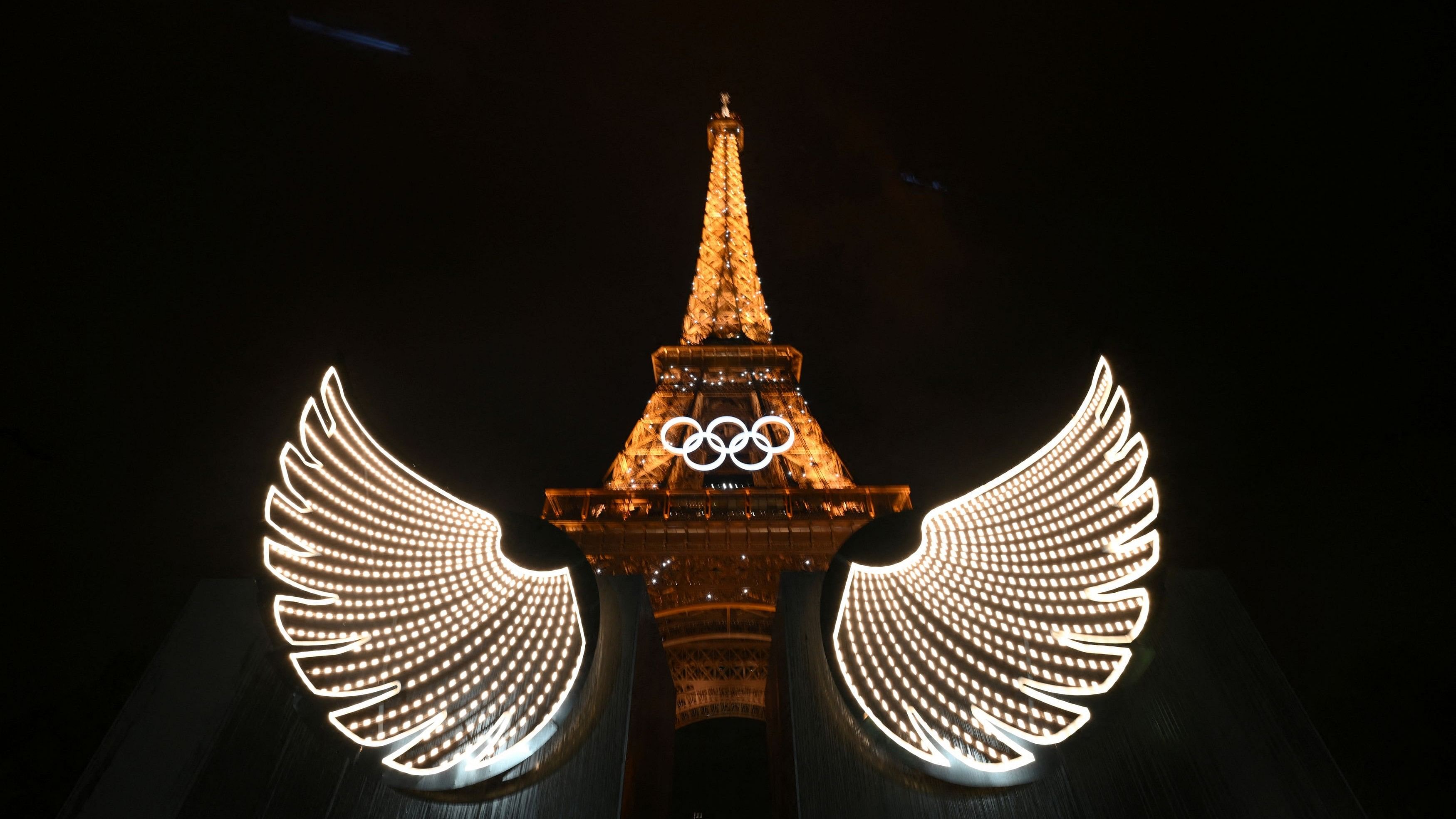 <div class="paragraphs"><p>A view shows the Eiffel Tower with illuminated wings in foreground after the opening ceremony of the Paris 2024 Olympic Games.</p></div>