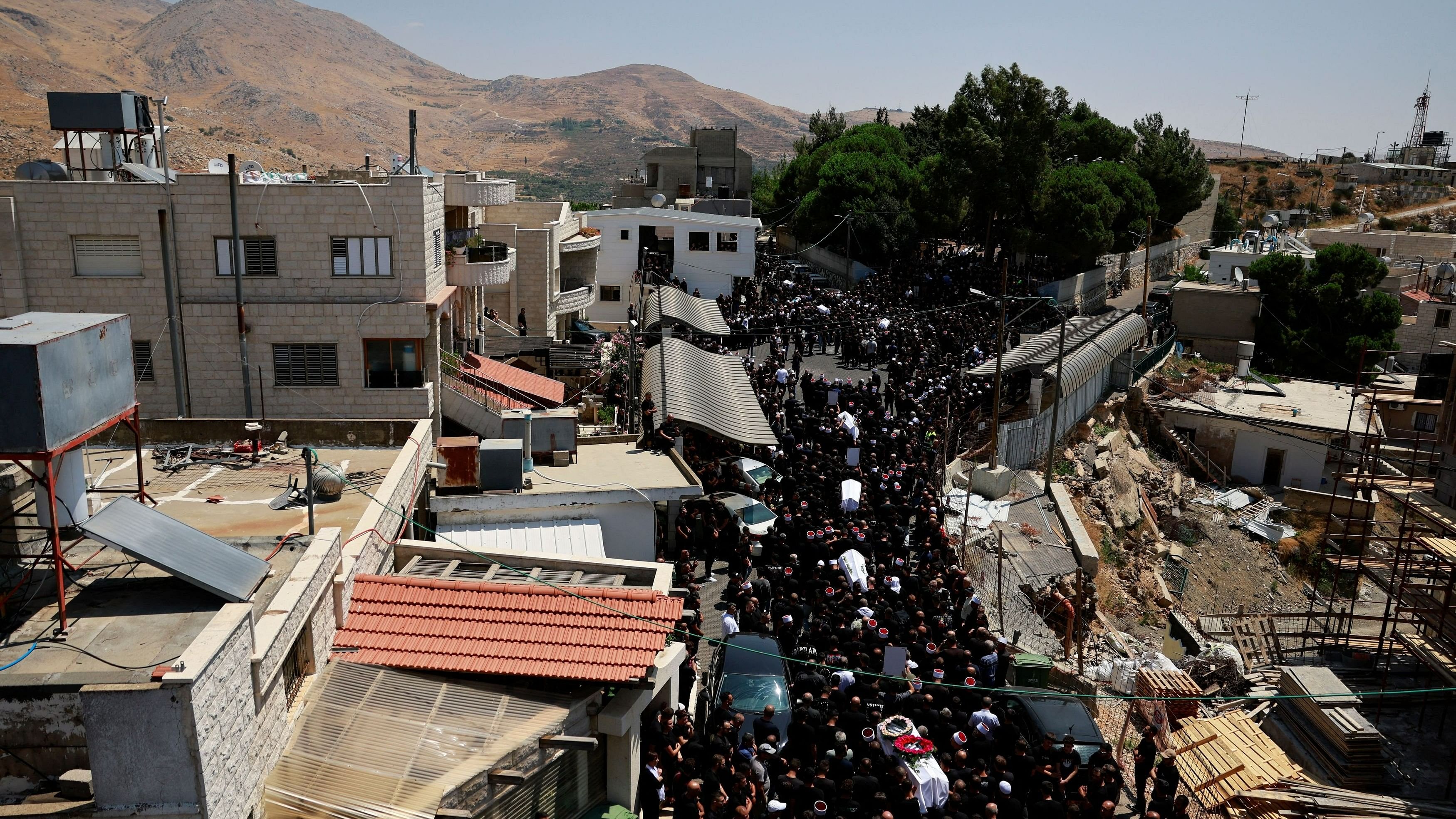 <div class="paragraphs"><p>Mourners carry coffins, during the funeral of children who were killed at a soccer pitch by a rocket fired from Lebanon, in Majdal Shams, a Druze village in the Israeli-occupied Golan Heights, July 28, 2024. </p></div>