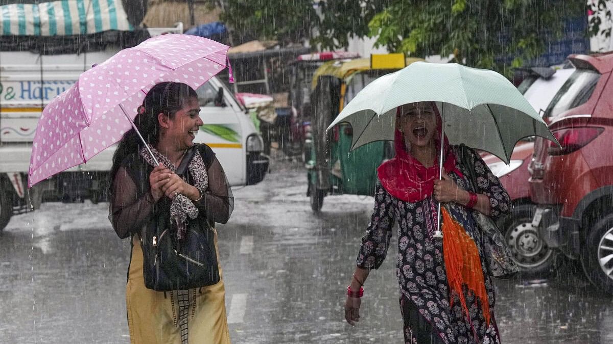 <div class="paragraphs"><p>People amid monsoon rains, in New Delhi</p></div>