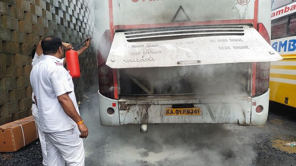 <div class="paragraphs"><p>Driver and conductor douse the fire using an extinguisher.</p></div>