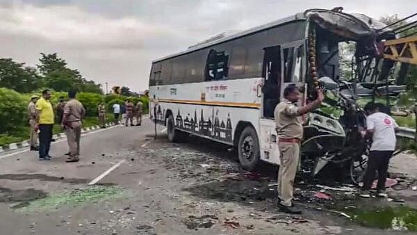 <div class="paragraphs"><p>Police personnel conduct investigation near a damaged vehicle after a collision between a Roadways bus and a private bus on the National Highway between Delhi and Bareilly, Monday, July 22, 2024.</p></div>