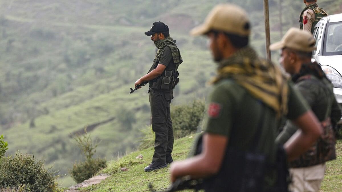 <div class="paragraphs"><p>Security personnel stand guard near the site of a recent terrorist attack, in Kathua district.</p></div>