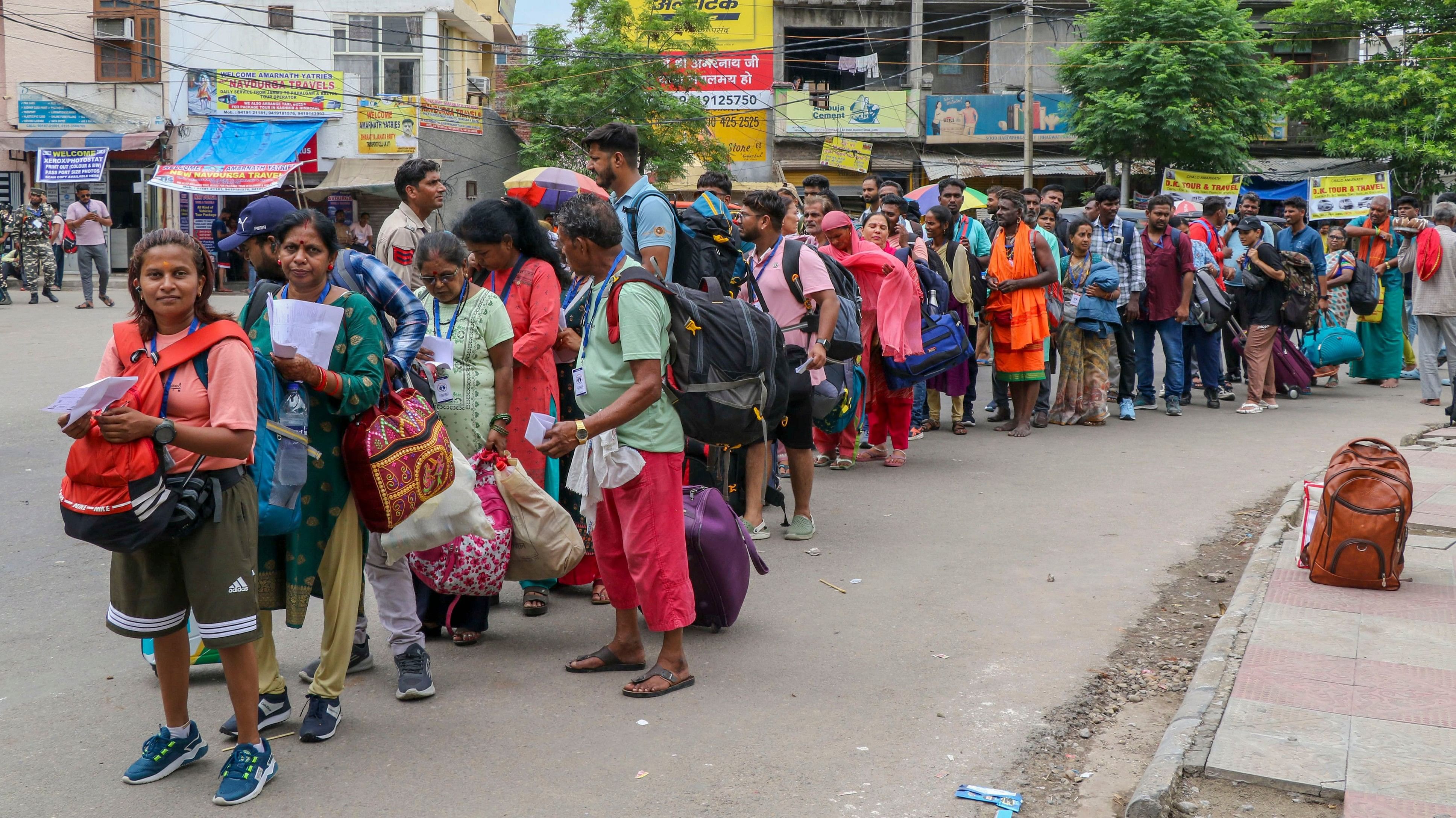 <div class="paragraphs"><p>Pilgrims wait in a queue to enter a base camp for the annual Amarnath Yatra.</p></div>