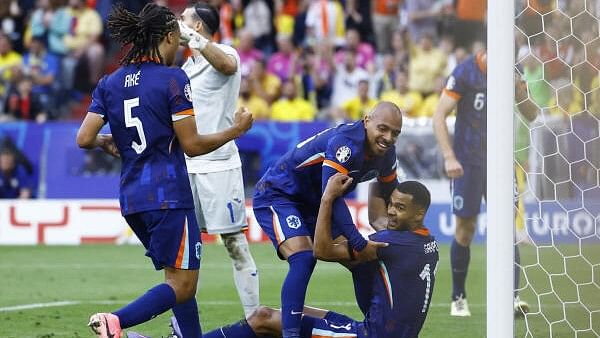 <div class="paragraphs"><p>Romania's Florin Nita reacts as Netherlands' Cody Gakpo celebrates scoring a goal  with Donyell Malen.</p></div>