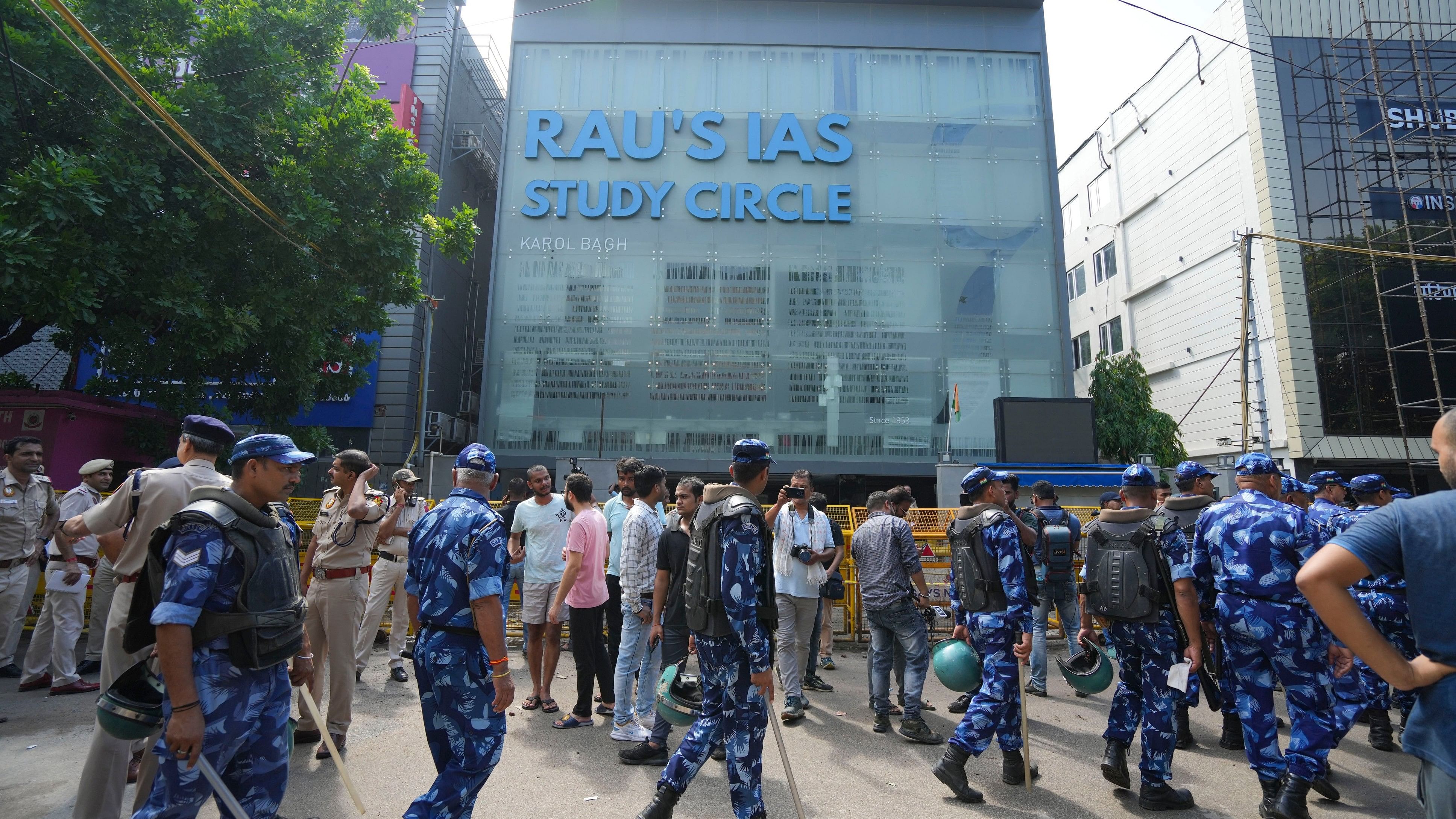 <div class="paragraphs"><p>Security personnel stand guard near a UPSC exam coaching centre after three civil services aspirants died when the basement of the coaching centre was flooded by rainwater, in New Delhi, Sunday, July 28, 2024.</p></div>