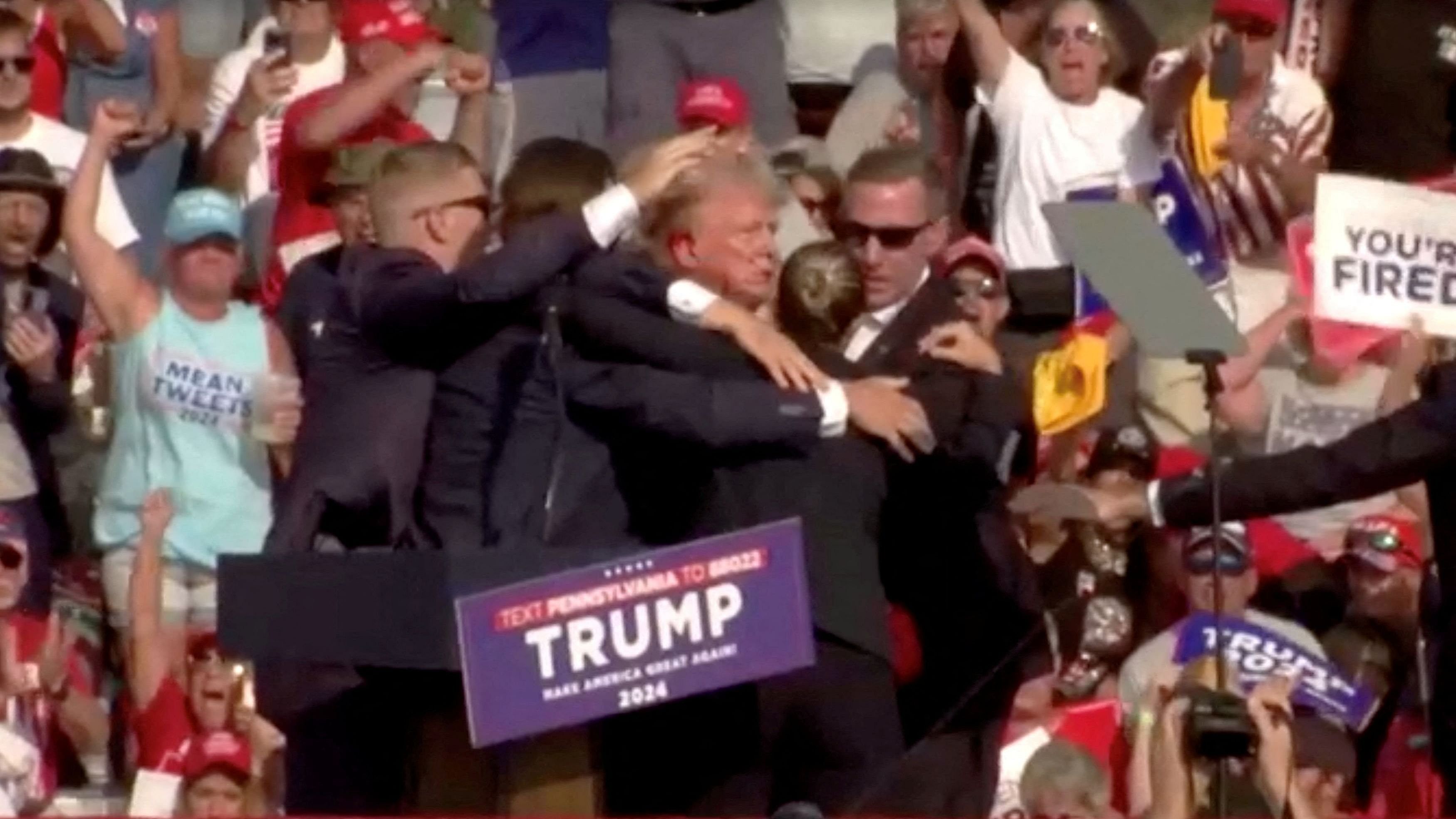 <div class="paragraphs"><p>Republican presidential candidate and former US President Donald Trump is assisted by security personnel after gunfire rang out during a campaign rally at the Butler Farm Show in Butler, Pennsylvania, July 13, 2024, in this screen grab taken from a video.</p></div>