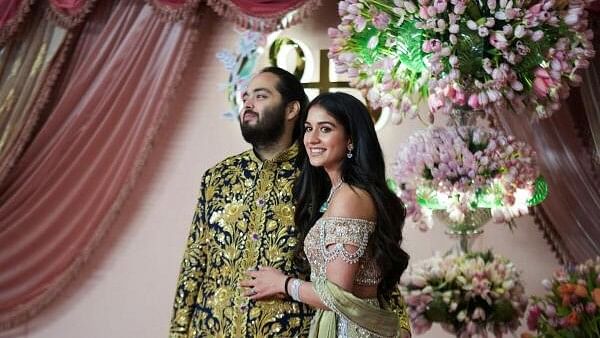 <div class="paragraphs"><p>Anant Ambani, son of businessman Mukesh Ambani, poses with his fiance Radhika Merchant on the red carpet during the sangeet ceremony at Jio World Centre, Mumbai.&nbsp;</p></div>