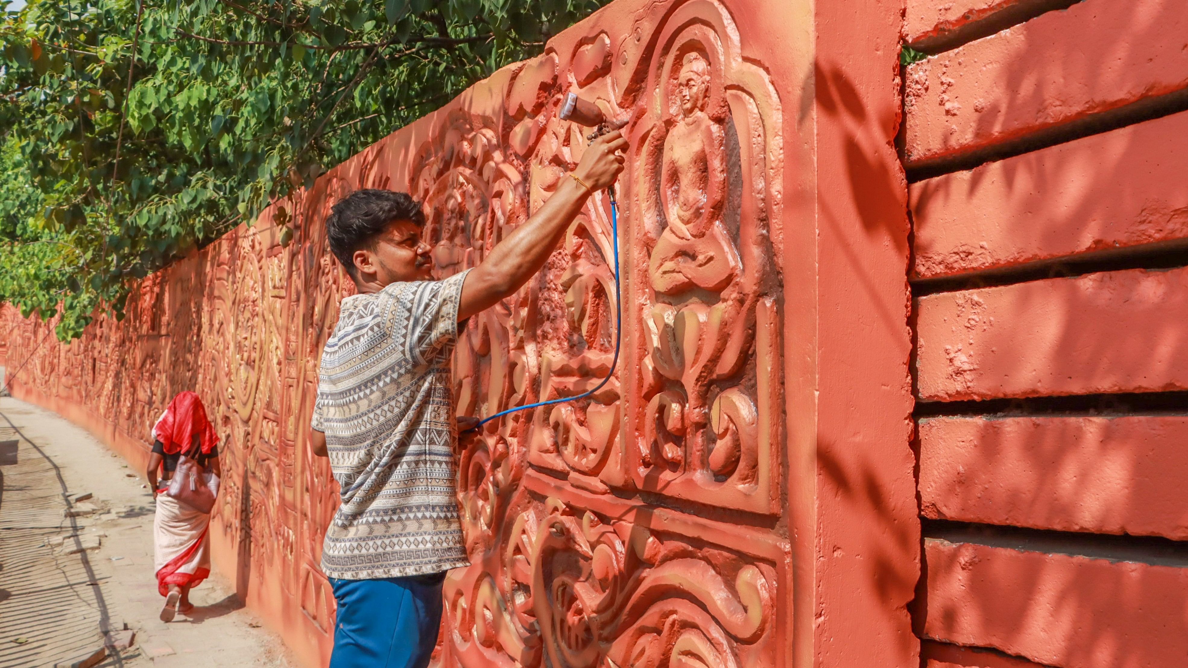 <div class="paragraphs"><p>An artist from Tripura makes wall mural as part of beautification work ahead 46th session of UNESCO's World Heritage Committee, scheduled from July 21 to 31, at ITO in New Delhi, Tuesday.</p></div>