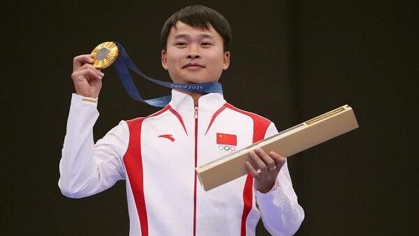 <div class="paragraphs"><p>Gold medalist China's Xie Yu poses on the podium at the end of the shooting 10m air aifle men's final during the Paris 2024 Olympic Games at Chateauroux Shooting Centre on July 28, 2024.</p></div>