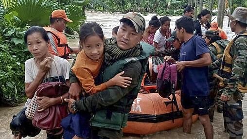 <div class="paragraphs"><p>An Assam Rifles personnel carries a girl during a rescue operation in a flood-affected area, at Bijoypur village in Diyun circle in Changlang district, Arunachal Pradesh, Tuesday.&nbsp;</p></div>