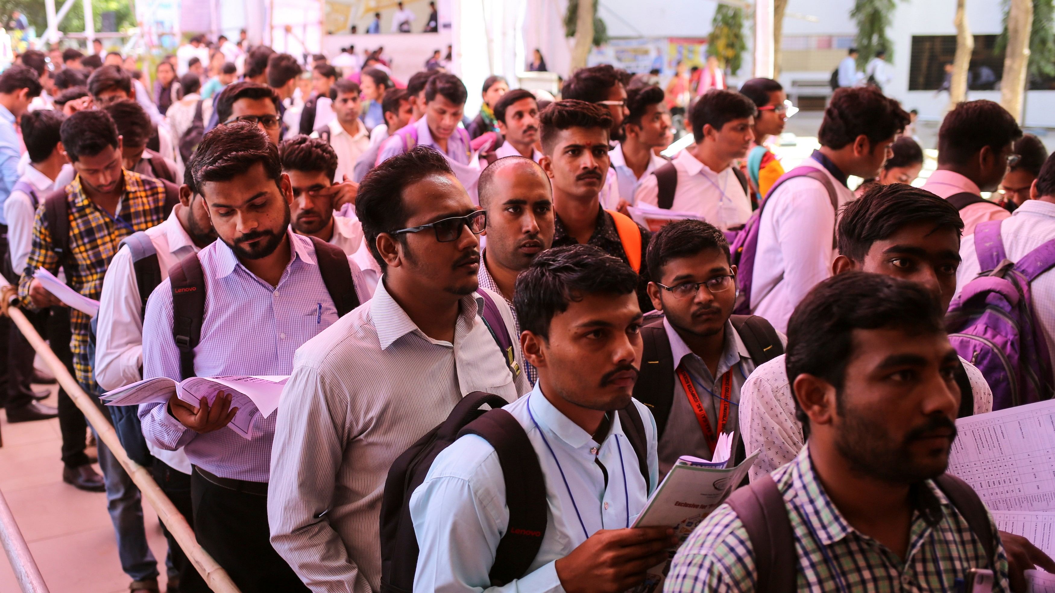 <div class="paragraphs"><p>Job seekers line up for interviews at a job fair</p></div>