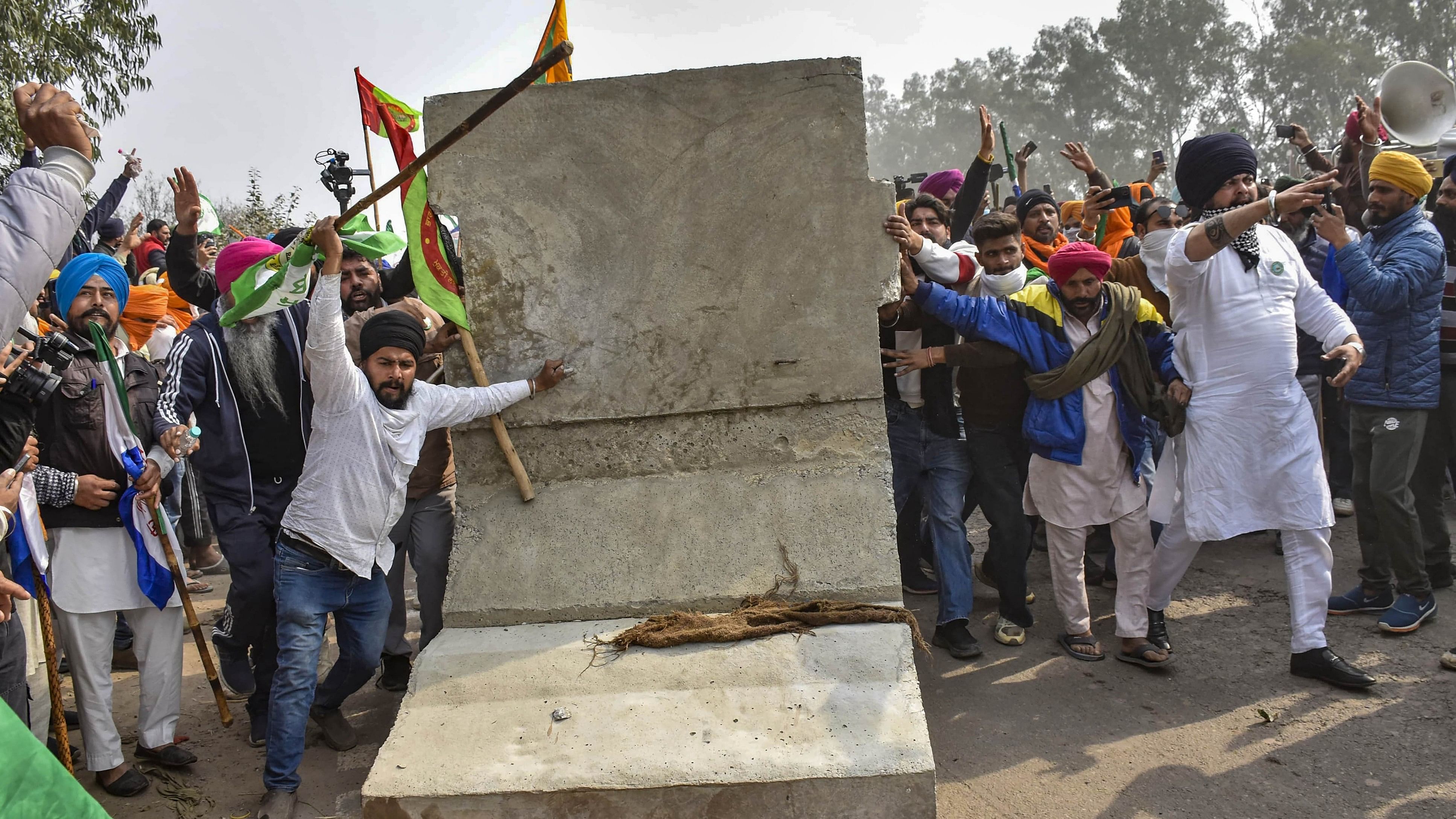 <div class="paragraphs"><p>Farmers try to remove a concrete barricade installed near Punjab-Haryana Shambhu border during their 'Delhi Chalo' march, near Patiala in February 2024. </p></div>