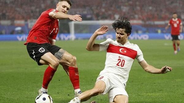 <div class="paragraphs"><p>Austria's Stefan Posch in action with Turkey's Ferdi Kadioglu.</p></div>