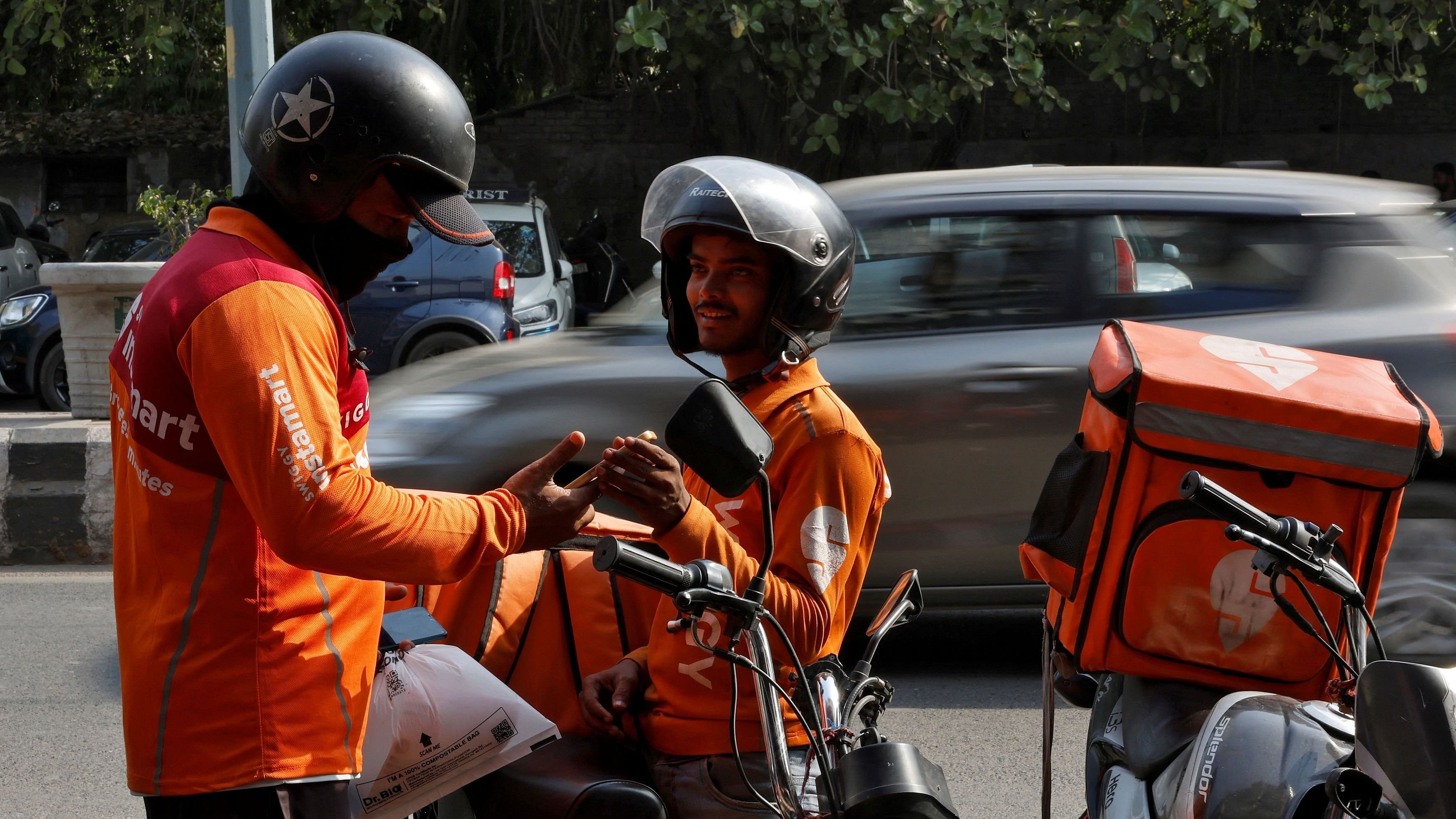 <div class="paragraphs"><p>Gig workers prepare to deliver orders outside Swiggy's grocery warehouse at a market area in New Delhi.</p></div>