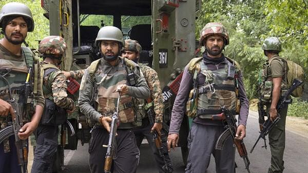 <div class="paragraphs"><p>Security personnel stand guard during an encounter with terrorists, in Kulgam, Saturday, July 6, 2024. </p></div>