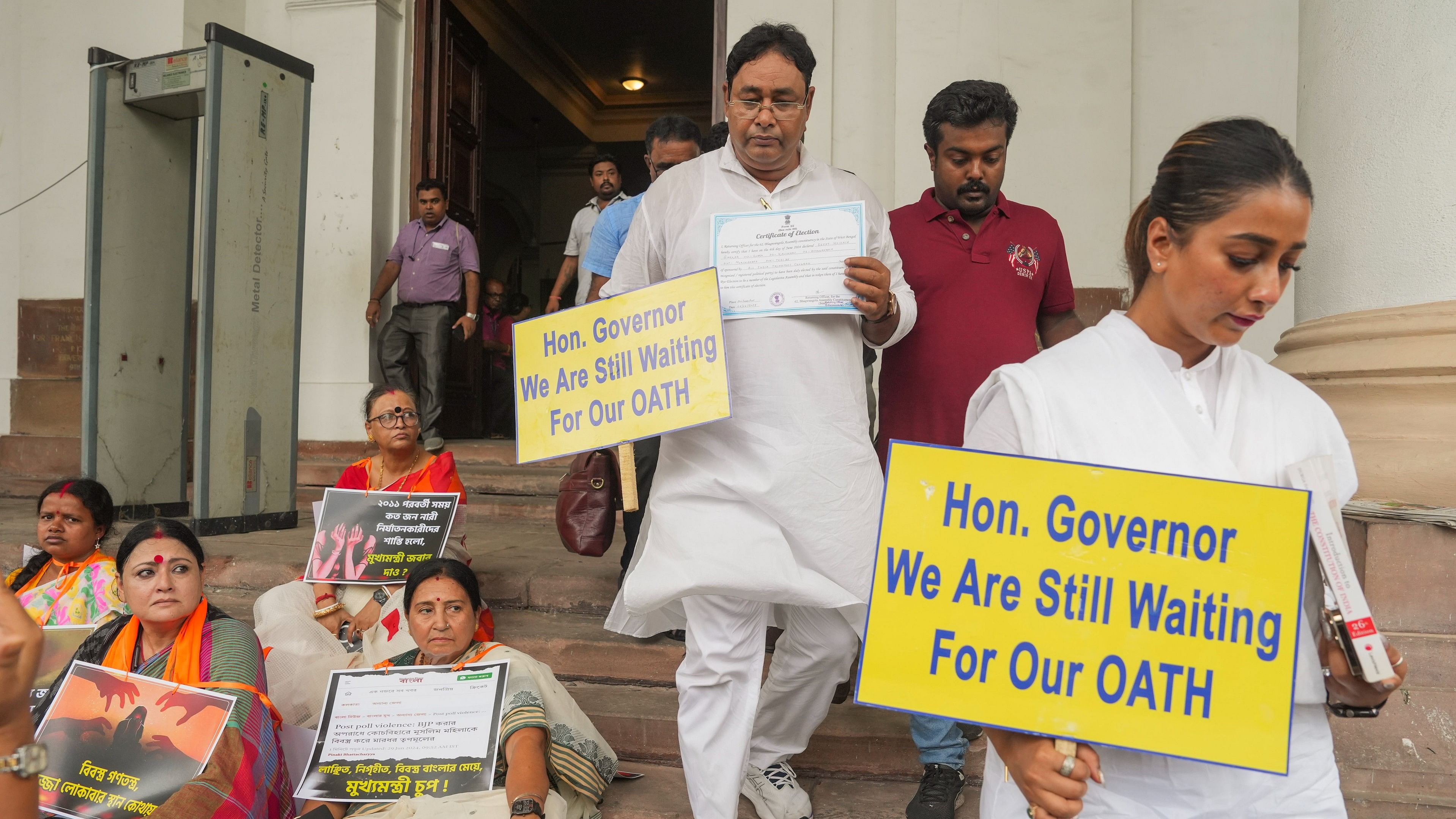 <div class="paragraphs"><p>Newly elected TMC MLAs Rayat Hossain Sarkar and Sayantika Banerjee walk for a sit-in protest for their swearing-in ceremony, in Kolkata.&nbsp;</p></div>