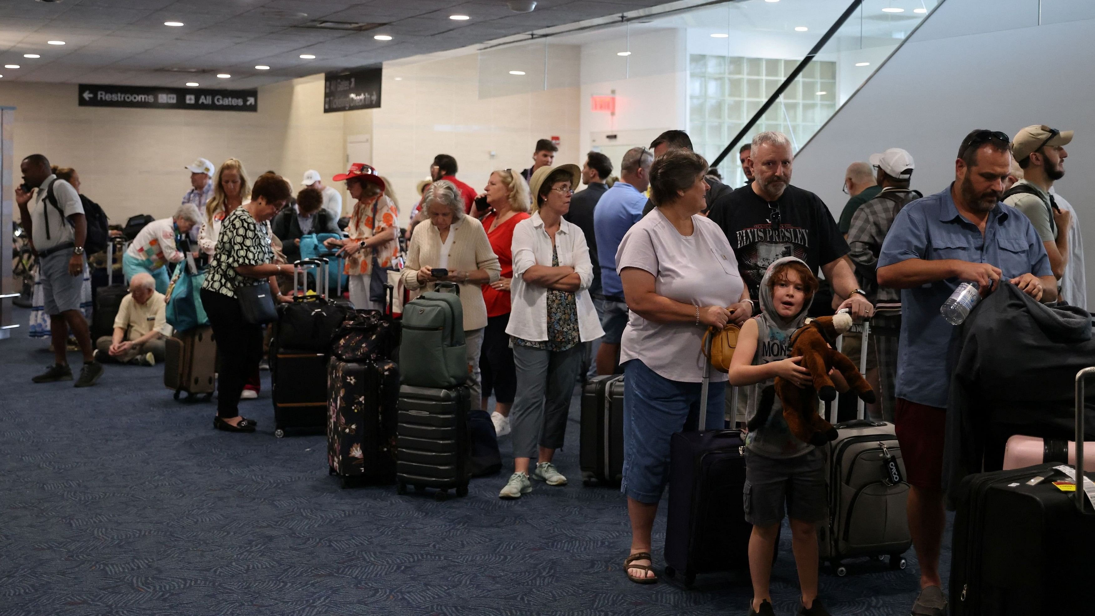 <div class="paragraphs"><p>Passengers wait at Milwaukee Mitchell International Airport, after airlines grounded flights due to a worldwide tech outage caused by an update to CrowdStrike's 'Falcon Sensor' software which crashed Microsoft Windows systems, in Milwaukee, Wisconsin.</p></div>