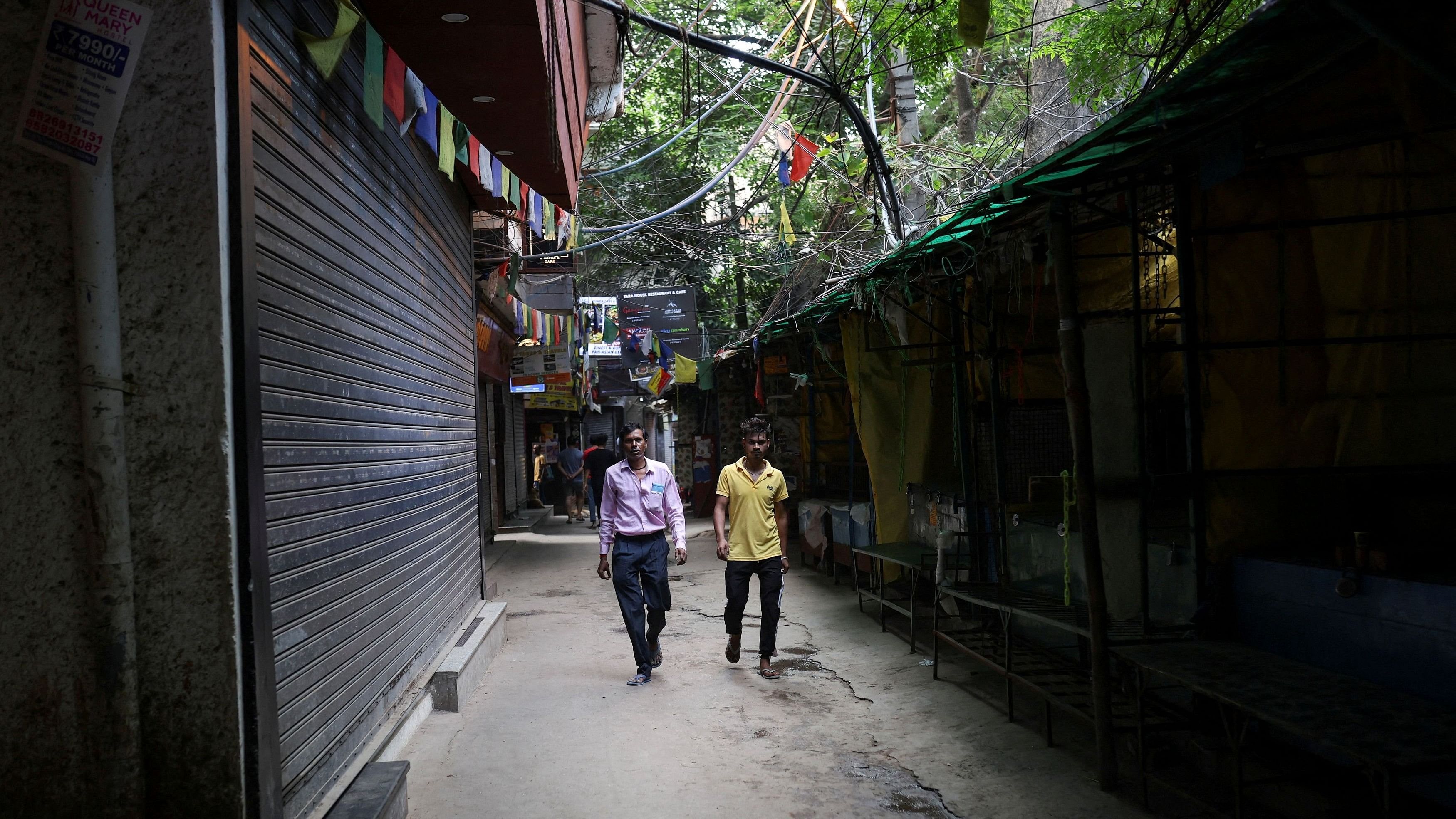 <div class="paragraphs"><p>People walking on an empty street in a refugee colony in Majnu ka Tila.</p></div>