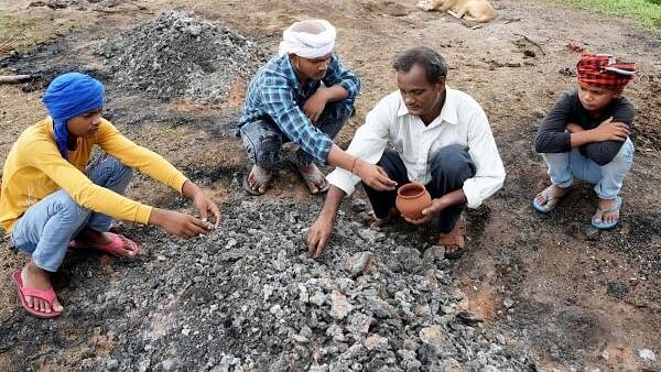 <div class="paragraphs"><p>A man named Vinod (in white) along with his sons performs last rites of his family members who were killed in a stampede during a 'satsang' on Tuesday, in Hathras, Thursday, July 4, 2024. Vinod's mother Jaya Manti (70), wife Rajkumari (40) and daughter Bhumi (10), who had gone to attend Bhole Baba's satsang got separated and went missing following a stampede at the venue. Their bodies were later found in three different districts - Agra, Hathras and Aligarh.</p></div>