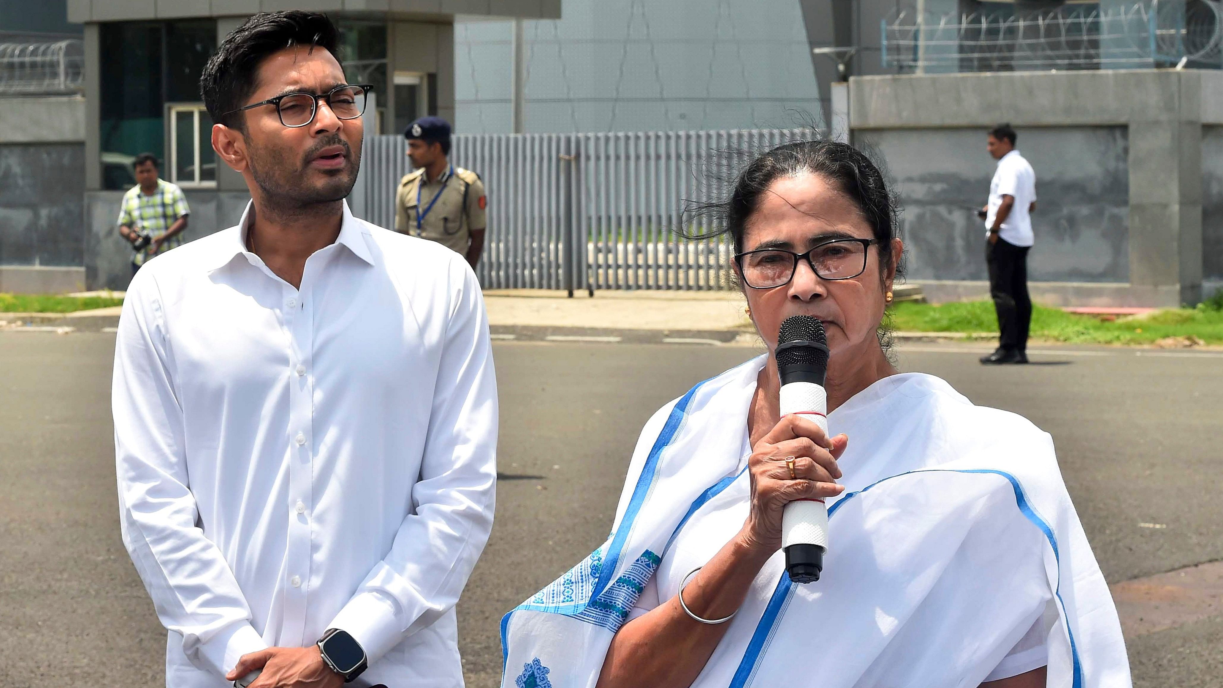 <div class="paragraphs"><p>West Bengal Chief Minister and TMC chief Mamata Banerjee with the party's National General Secretary Abhishek Banerjee addresses the media at the Netaji Subhash Chandra Bose International Airport in Kolkata, before leaving for Delhi</p></div>