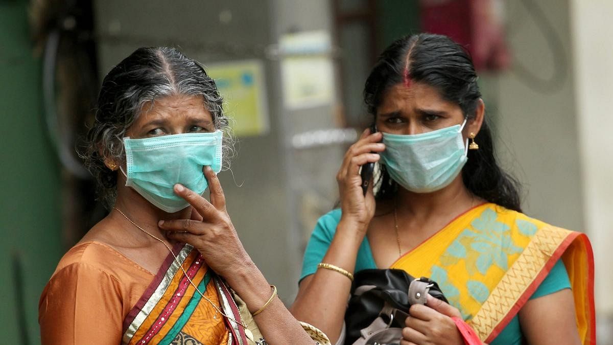 <div class="paragraphs"><p>Family members of a patient infected by Nipah virus wear safety masks at the Kozhikode Medical College hospital. </p></div>