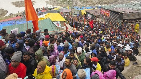 <div class="paragraphs"><p>Devotees stand in queue outside the Amarnath Temple to offer prayers during the annual ‘Amarnath Yatra'.</p></div>