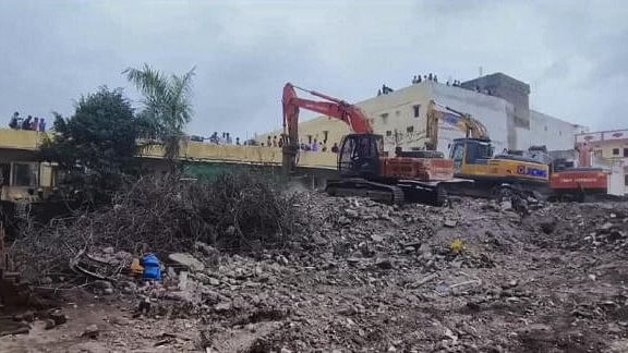 <div class="paragraphs"><p>Rescue operation underway after a building collapsed, in Surat, Sunday.&nbsp;</p></div>