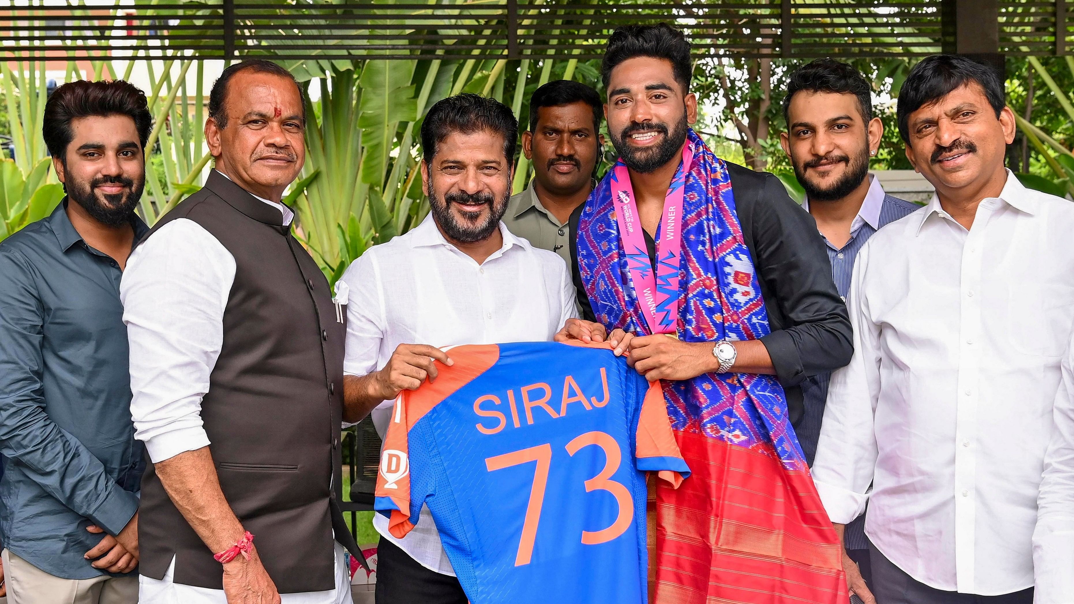 <div class="paragraphs"><p>Telangana Chief Minister A Revanth Reddy being presented a Team India cricket jersey by T20 Men's cricket World Cup winning team member Mohammed Siraj during a meeting, in Hyderabad, Tuesday, July 9, 2024. </p></div>