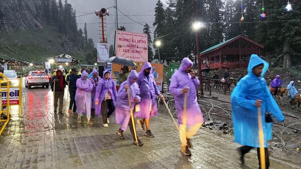 <div class="paragraphs"><p>Devotees amid rain at Baltal during the annual Amarnath Yatra.</p></div>