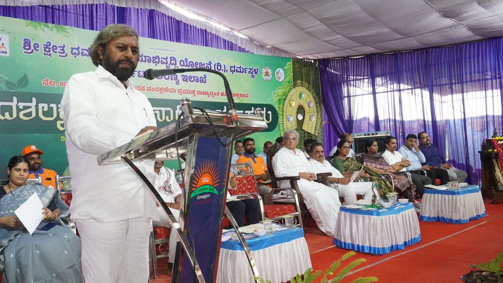 <div class="paragraphs"><p>Forest, Ecology and Environment Minister Eshwar Khandre speaks after launching social afforestation programme to plant 10 lakh saplings across the state organised by Shree Kshetra Dharmasthala Rural Development Project (SKDRDP) and forest department at Salumarada Thimmakka Tree Park at Alampuri in Bantwal taluk on Tuesday.</p></div>