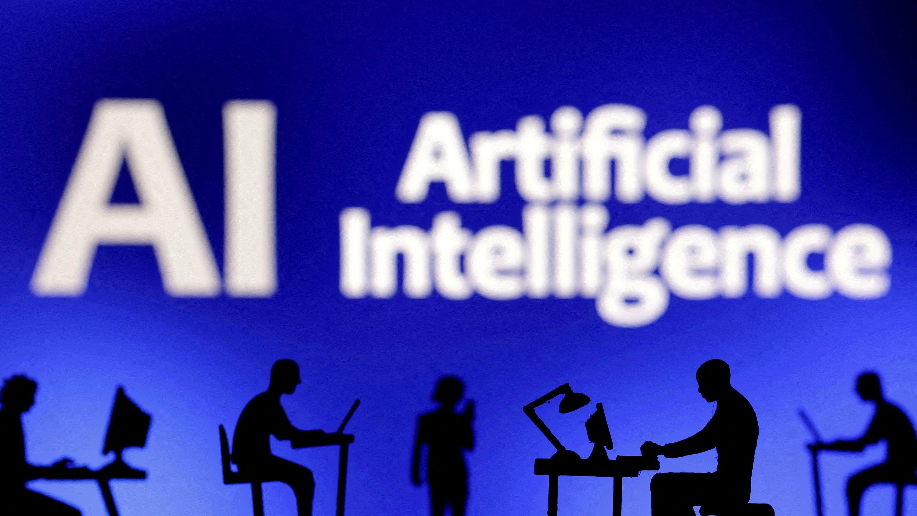 <div class="paragraphs"><p>Figurines with computers and smartphones are seen in front of the words "Artificial Intelligence AI" </p></div>