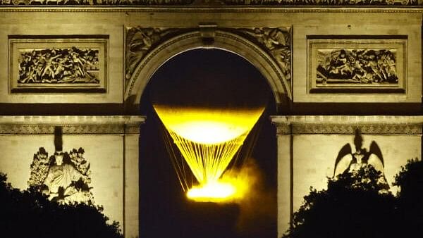 <div class="paragraphs"><p>The Olympic cauldron and the Arc de Triomphe after sunset during the Olympics.</p></div>