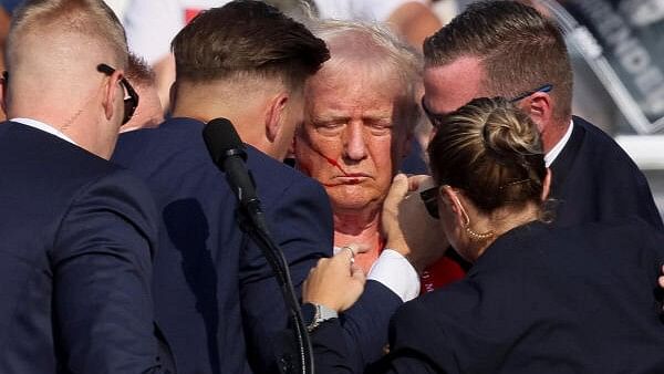 <div class="paragraphs"><p>Republican presidential candidate and former US president Donald Trump protected by the Secret Service after gunfire rang out during a campaign rally at the Butler Farm Show in Butler, Pennsylvania, US.</p></div>