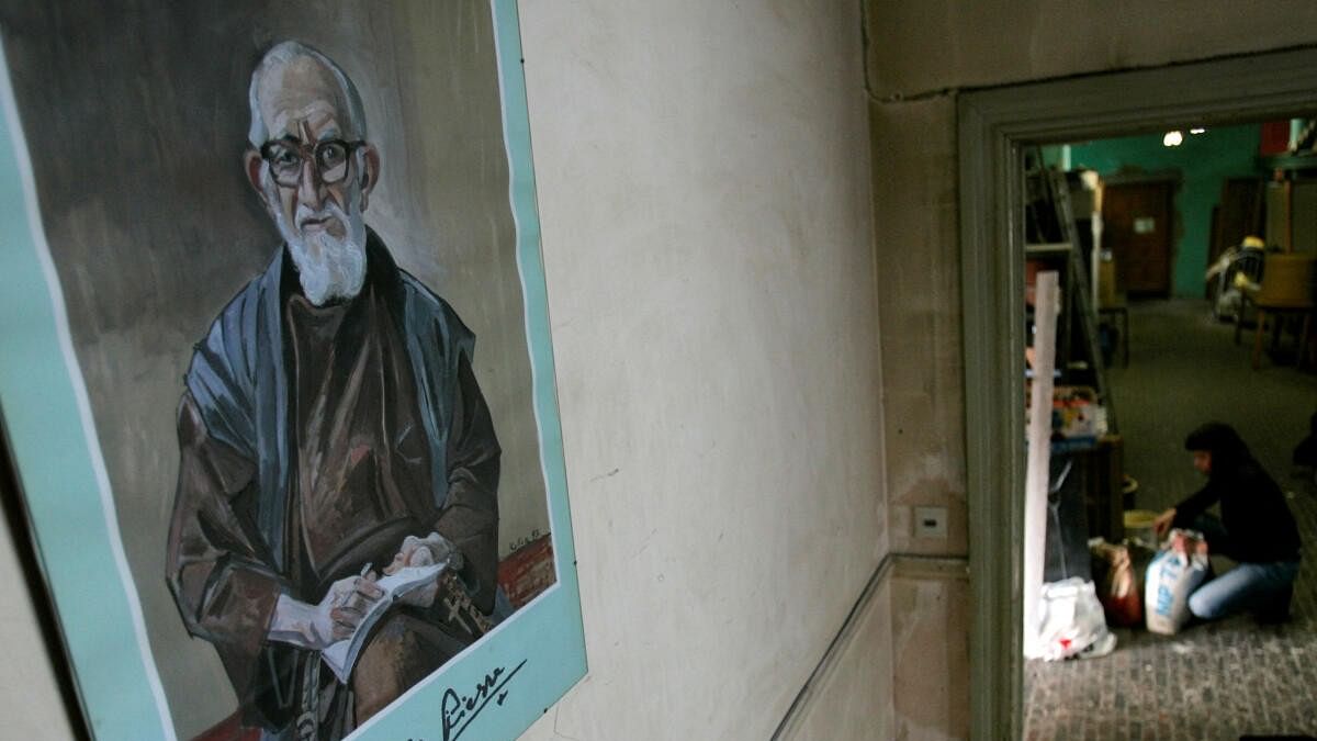 <div class="paragraphs"><p>A portrait of French priest Pierre hangs on a wall at La poudriere centre in Brussels.</p></div>