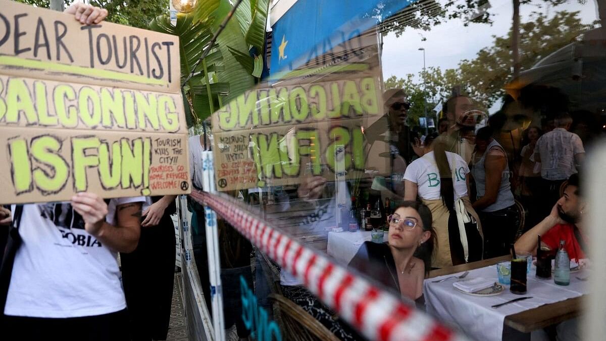 <div class="paragraphs"><p>People protest against mass tourism in Barcelona.</p></div>