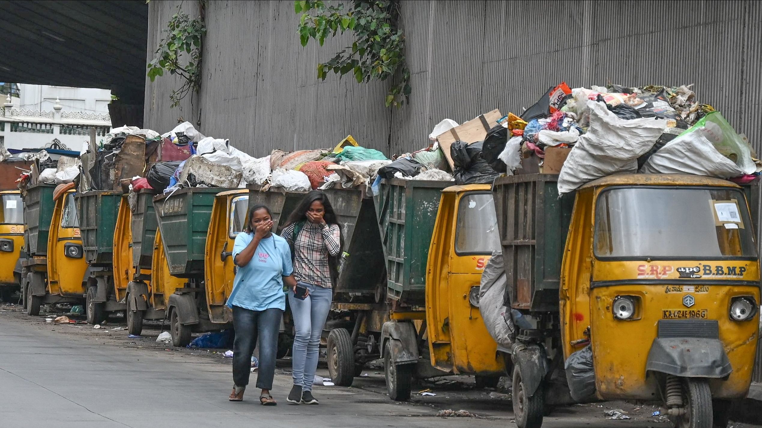 <div class="paragraphs"><p>Auto tippers filled with garbage on NR Road in the city on Wednesday. </p></div>